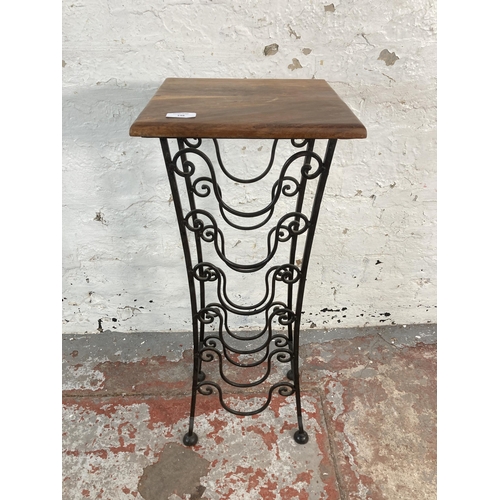 148 - An Indian sheesham wood and wrought iron six section bottle rack side table - approx. 76cm high x 30... 