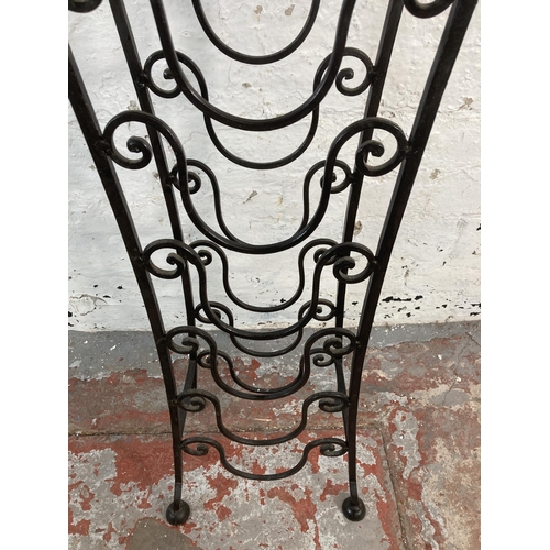 148 - An Indian sheesham wood and wrought iron six section bottle rack side table - approx. 76cm high x 30... 