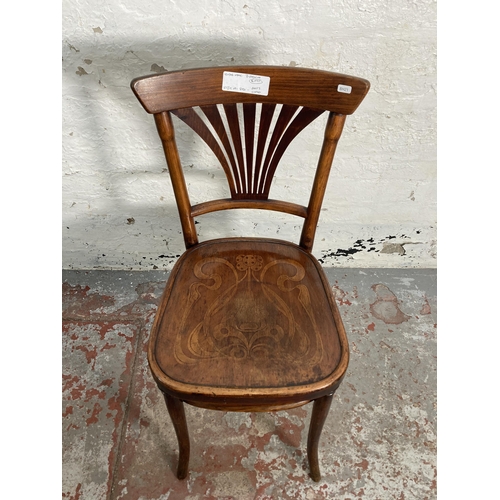 150 - A pair of early 20th century Thonet style bentwood bistro chairs with floral embossed seats