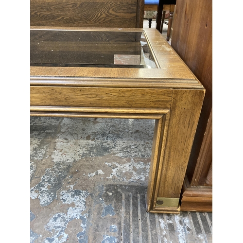 154 - A mid/late 20th century oak and bevelled glass rectangular coffee table - approx. 42cm high x 73cm w... 