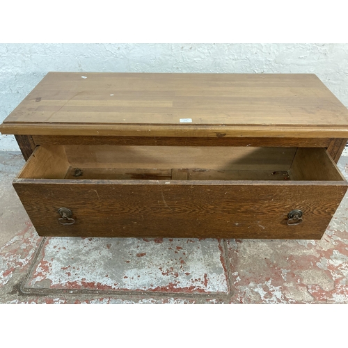 158 - An early 20th century oak wardrobe base with pine top