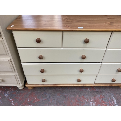 163 - A modern pine and cream painted chest of drawers - approx. 75cm high x 120cm wide x 38cm deep