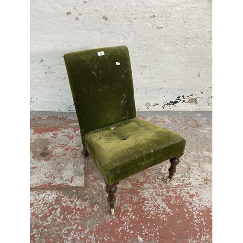 170 - A Victorian green fabric upholstered bedroom chair on mahogany supports and ceramic castors