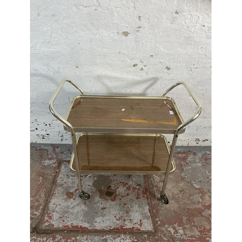 176 - A mid 20th century chrome plated and teak effect two tier tea trolley