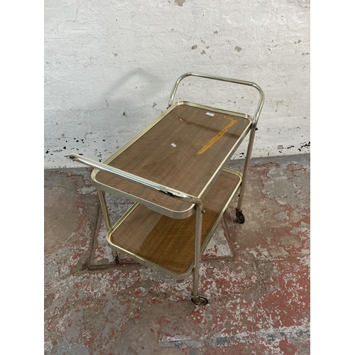 176 - A mid 20th century chrome plated and teak effect two tier tea trolley