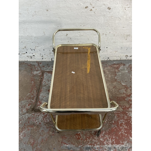 176 - A mid 20th century chrome plated and teak effect two tier tea trolley