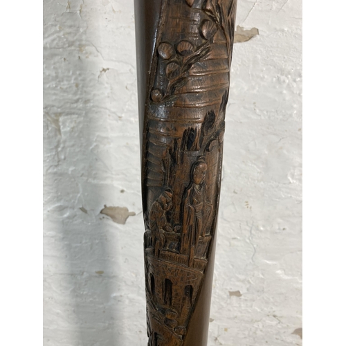 179 - A Chinese carved camphor wood standard lamp - approx. 150cm high