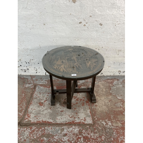 180 - A Chinese carved camphor wood circular tilt top occasional table with glass top - approx. 56cm high ... 