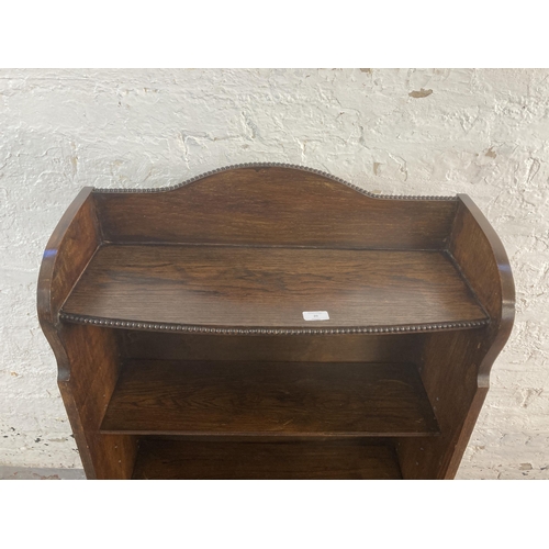 20 - An early 20th century oak four tier bookcase with beaded decoration - approx. 115cm high x 69cm wide... 