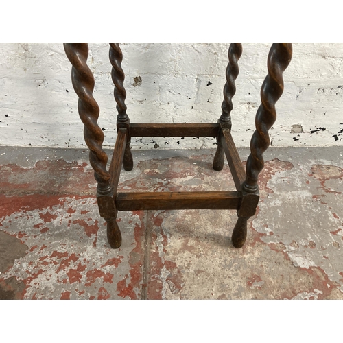 21 - An early 20th century oak barley twist side table - approx. 73cm high x 45cm wide