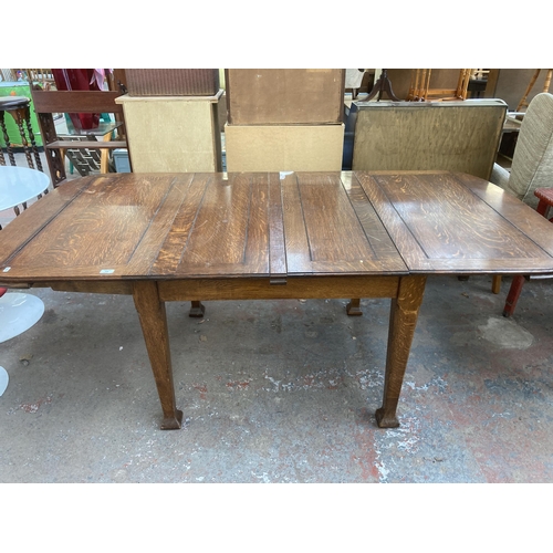 210 - An Arts and Crafts oak extending dining table - approx. 75cm high x 103cm wide x 196cm long