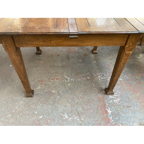 210 - An Arts and Crafts oak extending dining table - approx. 75cm high x 103cm wide x 196cm long