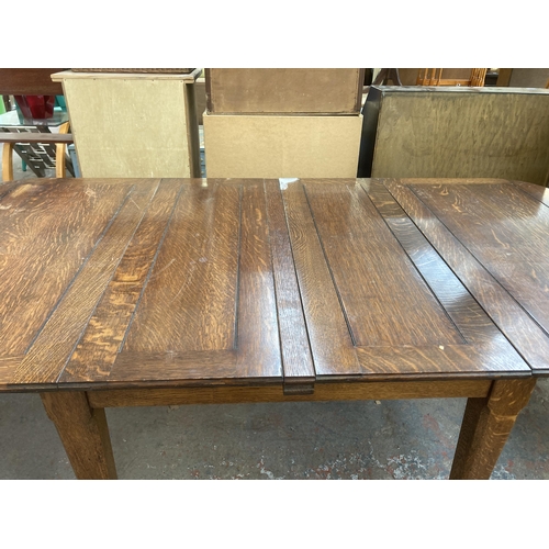 210 - An Arts and Crafts oak extending dining table - approx. 75cm high x 103cm wide x 196cm long