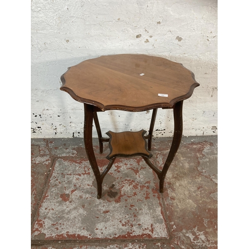 215 - An Edwardian mahogany serpentine two tier occasional table - approx. 70cm high x 65cm diameter