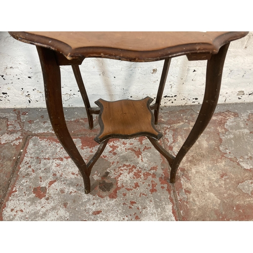 215 - An Edwardian mahogany serpentine two tier occasional table - approx. 70cm high x 65cm diameter