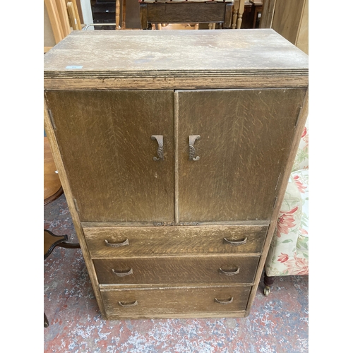 218 - A mid 20th century carved oak tall boy