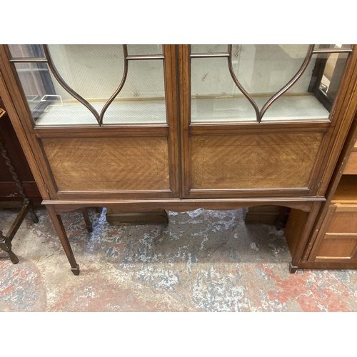 22 - An Edwardian inlaid mahogany display cabinet with two glazed doors - approx. 182cm high x 119cm wide... 