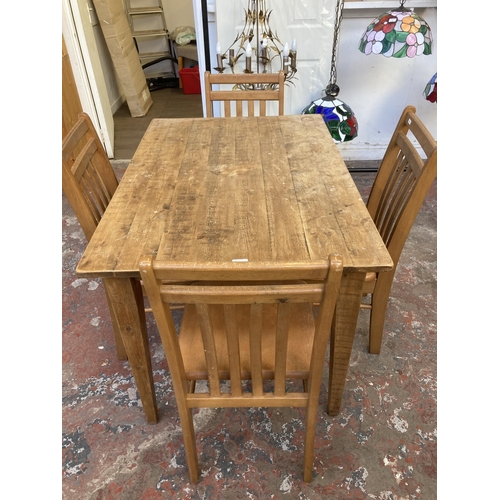 28 - A pine rectangular dining table and four beech dining chairs