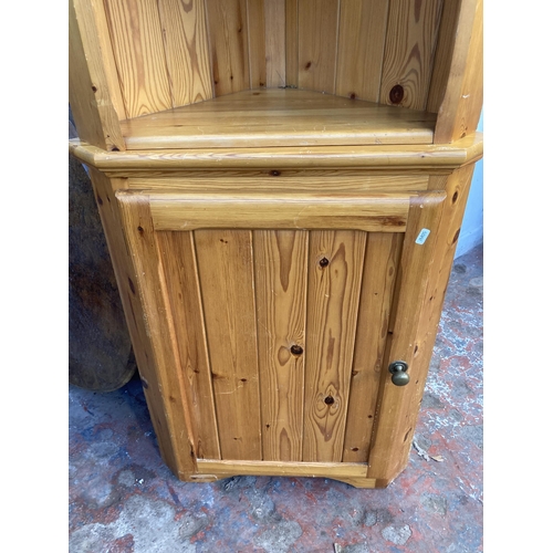 33 - A pine free standing corner cabinet - approx. 183cm high