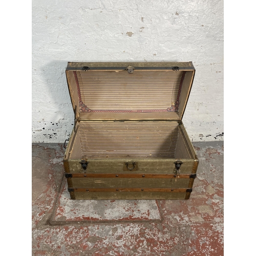 34 - An early 20th century green canvas and wooden banded dome top travel trunk - approx. 56cm high x 85c... 