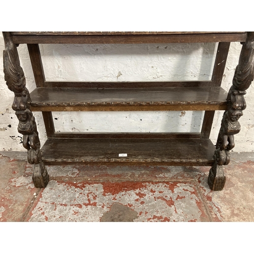 49 - A late 19th/early 20th century carved oak three tier shelving unit - approx. 80cm high x 85cm wide x... 