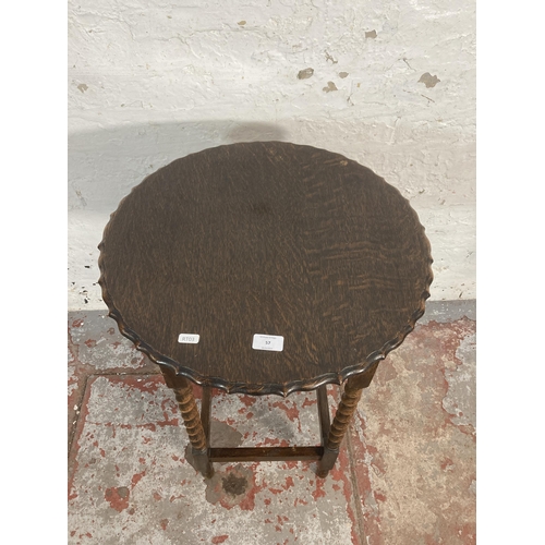 57 - An early 20th century oak pie crust edge barley twist side table - approx. 73cm high x 50cm diameter