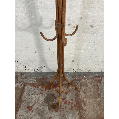 58 - A wicker and cane coat stand - approx. 174cm high