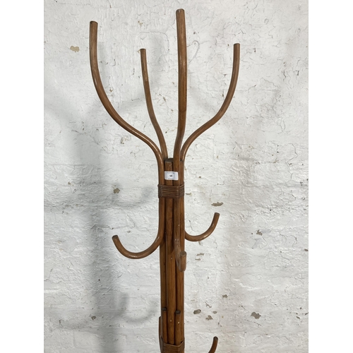 58 - A wicker and cane coat stand - approx. 174cm high