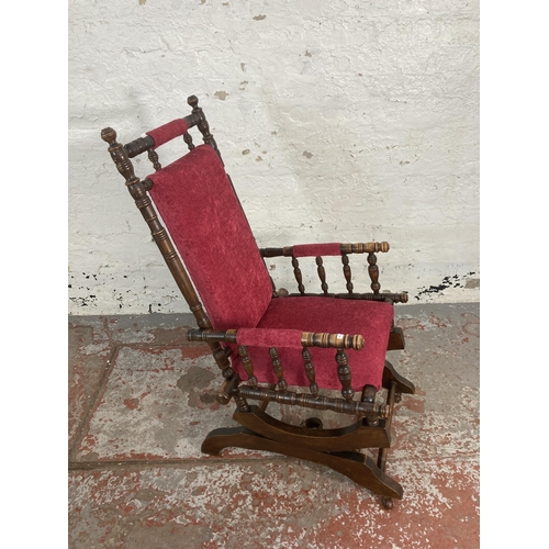 59 - An early 20th century American stained beech and fabric upholstered rocking chair