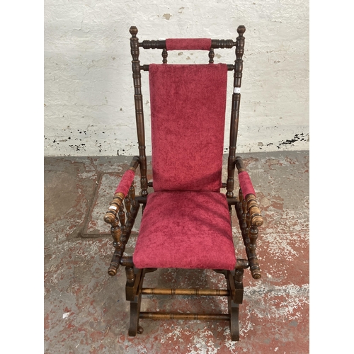 59 - An early 20th century American stained beech and fabric upholstered rocking chair