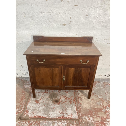 65 - An Edwardian carved mahogany two door cabinet - approx. 83cm high x 91cm wide x 48cm deep