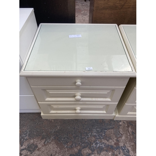 68 - A pair of modern white laminate bedside chest of drawers - approx. 63cm high x 64cm wide x 57cm deep