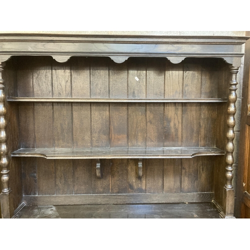 7 - An early 20th century oak dresser - approx. 196cm high x 134cm wide x 51cm deep