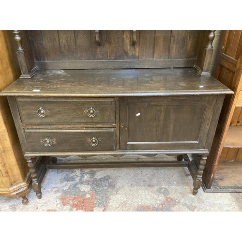 7 - An early 20th century oak dresser - approx. 196cm high x 134cm wide x 51cm deep