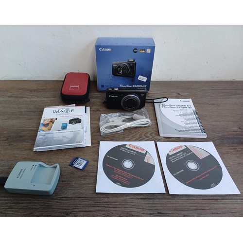 315A - A boxed and cased Canon PowerShot SX260 HS 12.1mp compact digital camera with charger, software disc... 