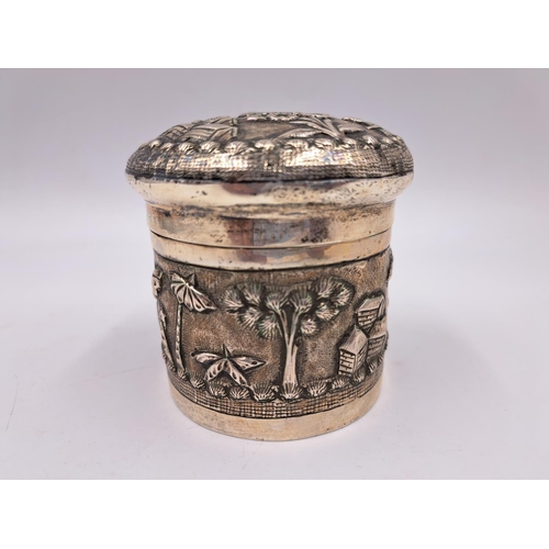 2428 - A late 19th century Indian white metal lidded tea caddy with embossed village scene decoration - app... 