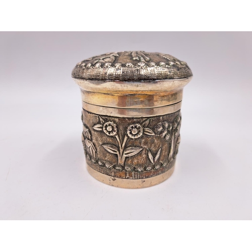 2428 - A late 19th century Indian white metal lidded tea caddy with embossed village scene decoration - app... 