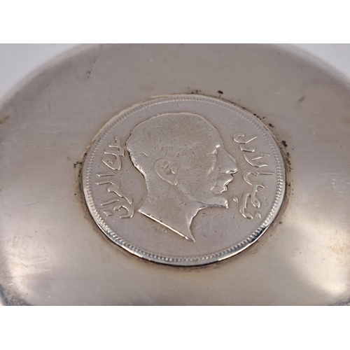 2431 - An Iraqi white metal one riyal coin dish - approx. gross weight 44g and 8.5cm diameter