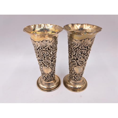 2437 - A pair of Victorian William Comyns & Sons hallmarked London silver pierced repousse bud vases, dated... 