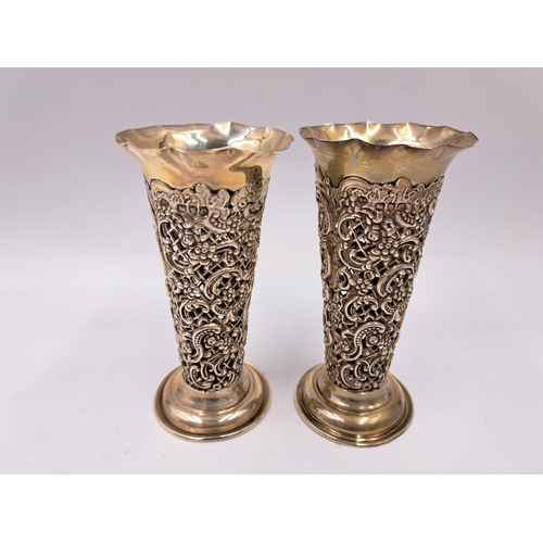 2437 - A pair of Victorian William Comyns & Sons hallmarked London silver pierced repousse bud vases, dated... 