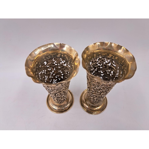 2437 - A pair of Victorian William Comyns & Sons hallmarked London silver pierced repousse bud vases, dated... 