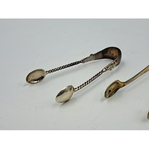 2450 - Two pairs of hallmarked Birmingham silver sugar tongs, one Liberty & Co. Ltd. and one Thomas Hayes -... 