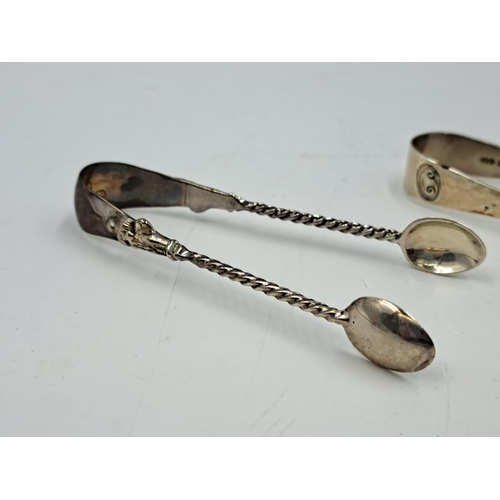 2450 - Two pairs of hallmarked Birmingham silver sugar tongs, one Liberty & Co. Ltd. and one Thomas Hayes -... 