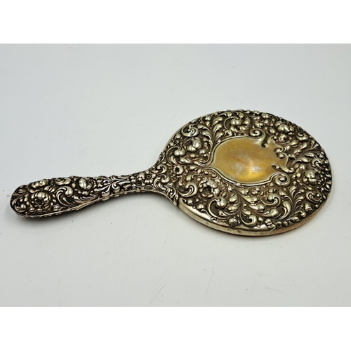 2497 - Two sterling silver vanity mirrors, one hallmarked Birmingham and one repousse