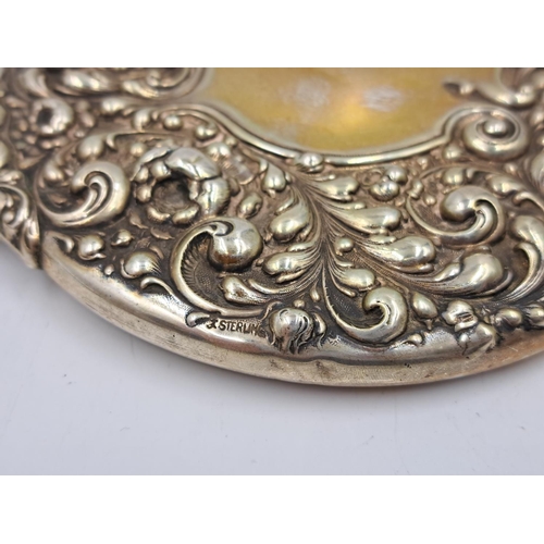 2497 - Two sterling silver vanity mirrors, one hallmarked Birmingham and one repousse