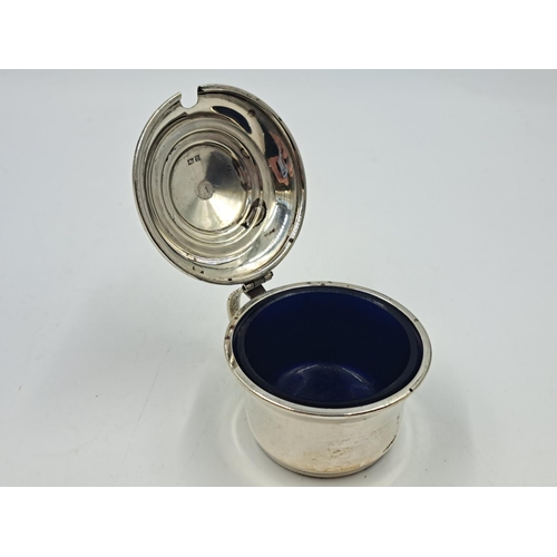 2498 - A Lanson Ltd. hallmarked Birmingham silver condiment pot with spoon and blue glass insert - approx. ... 