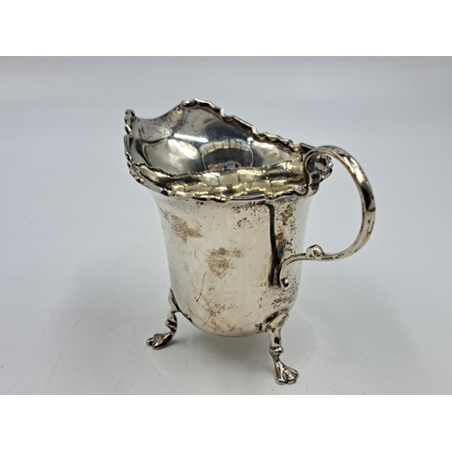 2500 - A George V Charles Weale hallmarked Birmingham silver creamer on tri-footed supports, dated 1927 - a... 