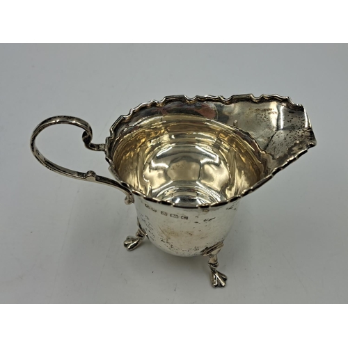 2500 - A George V Charles Weale hallmarked Birmingham silver creamer on tri-footed supports, dated 1927 - a... 