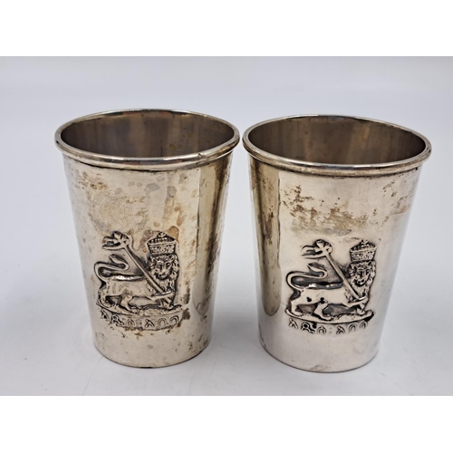 2511 - A pair of 20th century B.A. Sevadjian Ethiopian .830 silver drinking cups with embossed lion design ... 