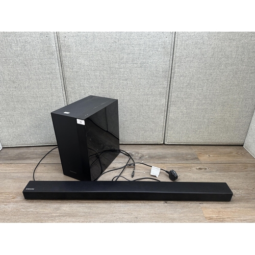 406 - A Samsung TV speaker system comprising PS-WK450 subwoofer and HW-K450 soundbar